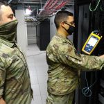 technician installing fibre optic cables