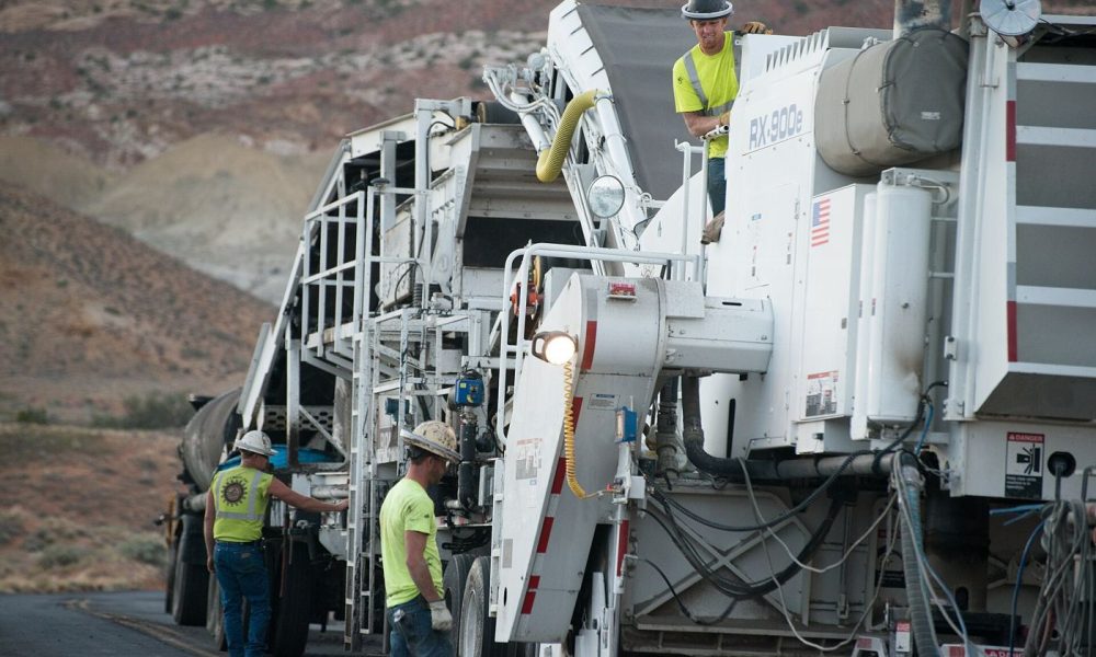 workers resurfacing a road with fresh asphalt