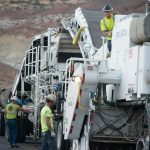 workers resurfacing a road with fresh asphalt