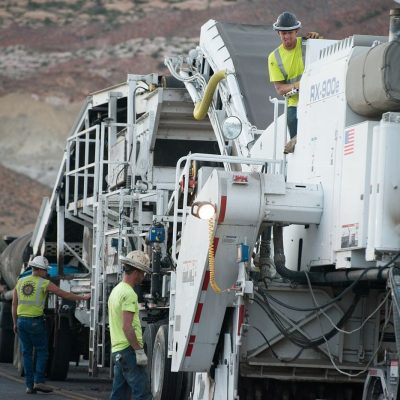 workers resurfacing a road with fresh asphalt