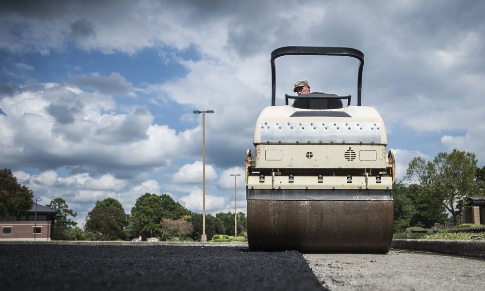 workers resurfacing a road with asphalt