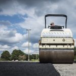 workers resurfacing a road with asphalt