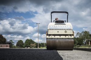 workers resurfacing a road with asphalt