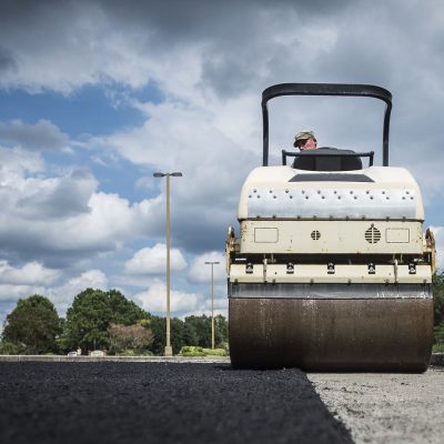 workers resurfacing a road with asphalt